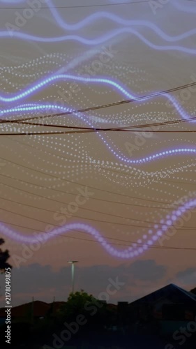 Animation of glowing waves overlaying silhouetted power lines against sky