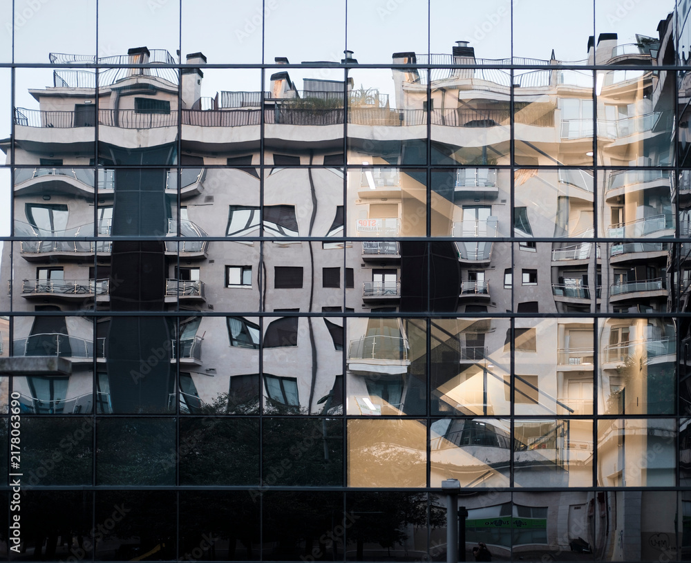 Obraz premium Modern mirrored glass building reflecting urban architecture in Donostia San Sebastian Spain
