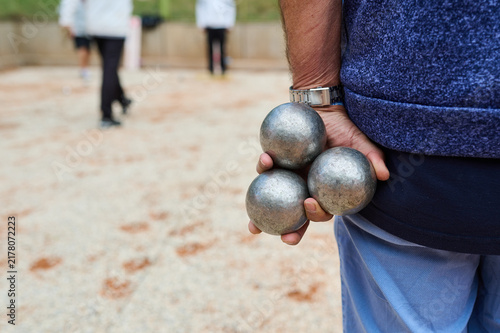 Senior Man Holding Metal Petanque Boules Behind Back Outdoor Game