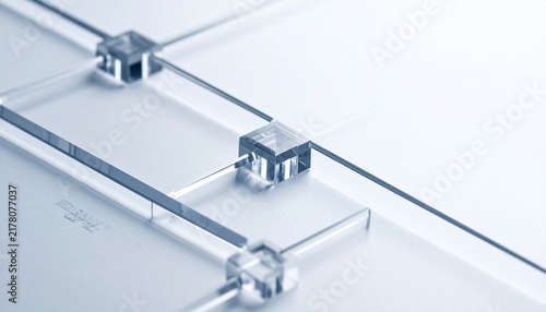Microfluidic Chip Laboratory Design: A close-up, high-angle view of a meticulously crafted microfluidic chip, showcasing its intricate channels and connectors against a clean.