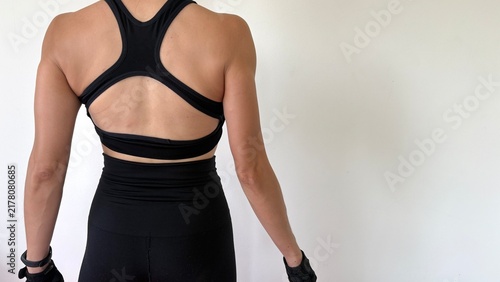 Photography Medium shot , Fitness woman turn back to camera show her back muscle stand poses , white background