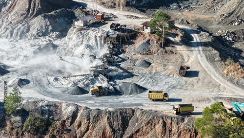 Принти на полотні Industrial stone crushing plant operating with heavy equipment in a dusty quarry