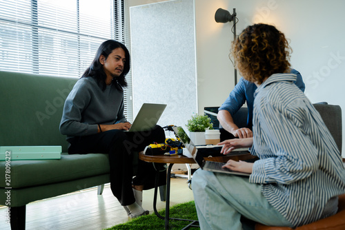 Naklejka software developer talk strategy plan to executive write prompt AI bot IT app program data analytics in tech startup office.Projected visuals and glowing code on screen.AI chatbot technology concept