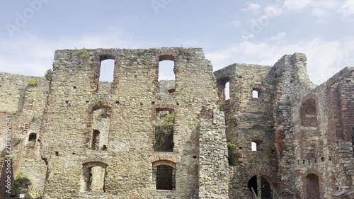 Old stone castle ruins with broken walls and windows under a bright cloudy sky. Zamek w Siewierzu  Poland, Siewierz, 5.08.2026  
