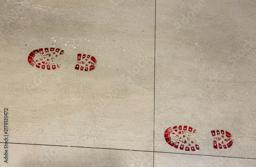 red bloody footprints on grey floor, halloween banner concept of halloween, crime, party