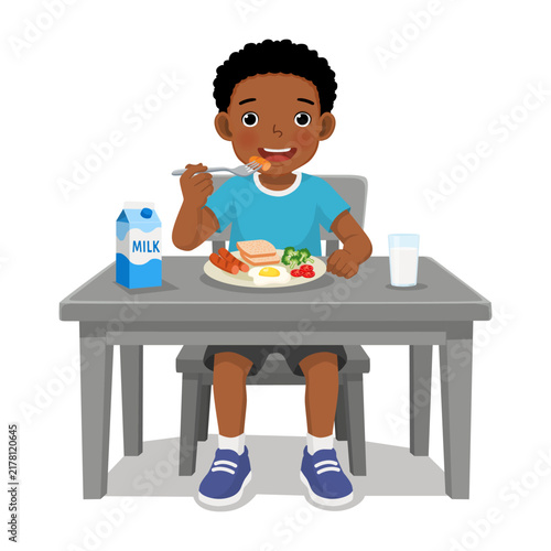 Little boy having breakfast with healthy food with milk isolated on white background