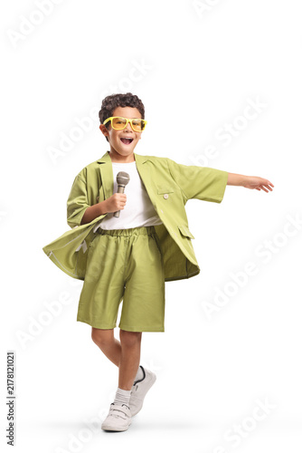 Obraz na płótnie Boy singing into a microphone and dancing