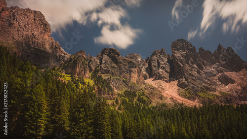 Majestic Rocky Peaks of Pale di San Martino Rising Above Alpine Pine Forest - Dolomites Italy