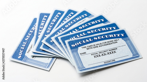 Fan of blue social security cards, showcasing official identification and personal data, representing security and identity.
