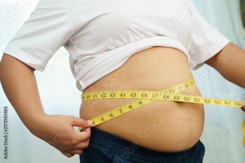 Konstfotografi Asian woman use hand to squeeze fat belly big size overweight and obesity