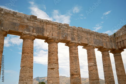 Low angle horizontal view of Doric colonnade and stone entablature of ancient Greek temple in Segesta, Sicily, Italy