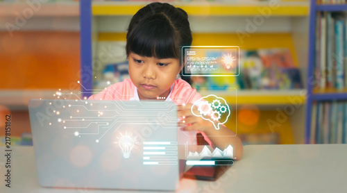 Asian schoolgirl using laptop computer with futuristic digital interface overlay showing brain gears, lightbulb idea icon, and data circuit for AI education and smart kid concept.