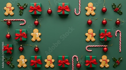 Christmas flat lay composition with gingerbread cookies gifts and ornaments on green background