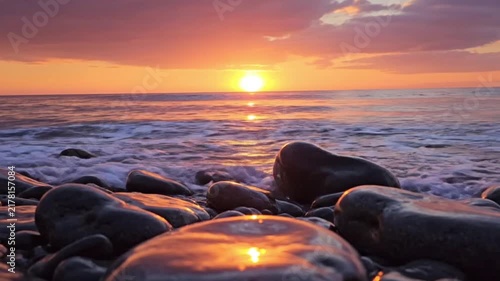 Mesmerizing view of sunset over sea stones
