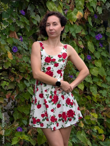 Woman in Red Rose Dress Posing in Garden