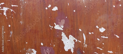 Reddish wooden background with peeled white spots