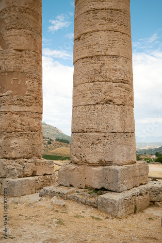 Vertical detailed view of ancient Greek Doric stone column shafts and bases at Segesta temple in Sicily, Italy