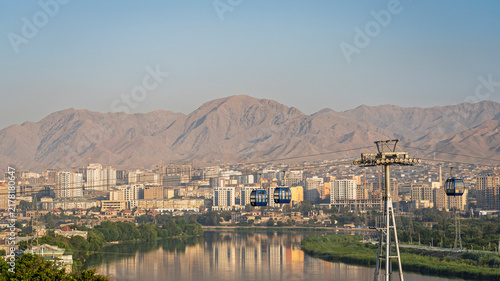 Scenic cityscape view of Syr Darya river in Khujand city with cable car and Mogoltau mountains at sunrise, Sughd, Tajikistan