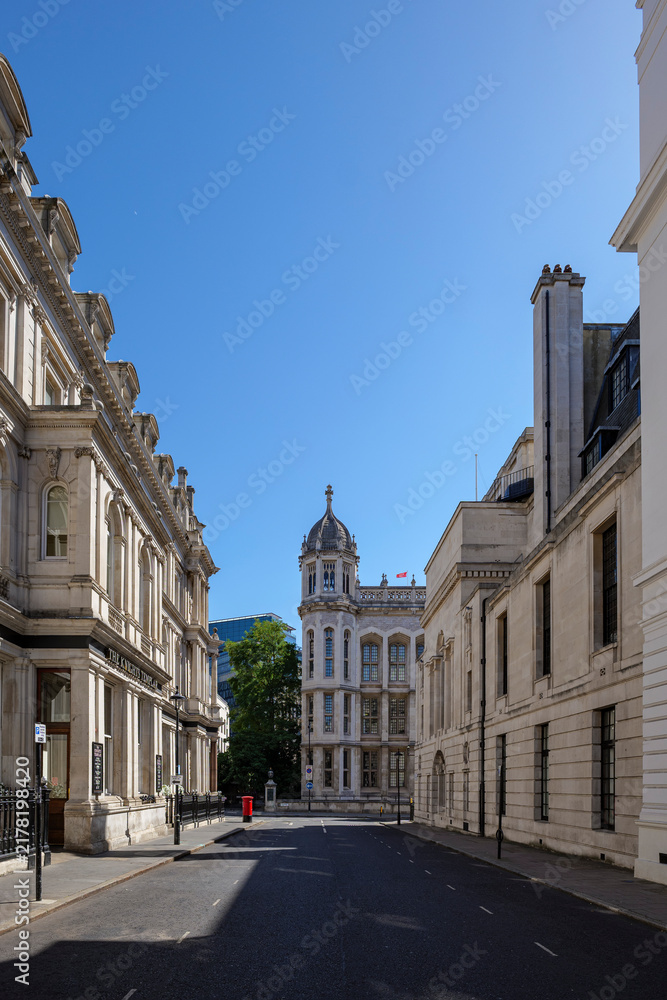 Fototapeta premium London - 07 24 2022: Carey Street historic stone façades with domed tower and red post box