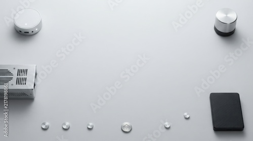 Modern electronic gadgets and metal buttons arranged on a plain surface