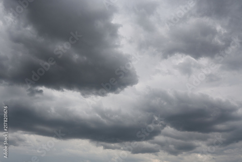 Stratocumulus Dramatic Dark Storm Clouds with Sunlight Breaking Through Over Blue Sky