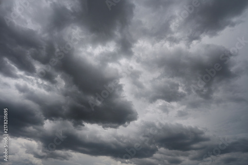 Stratocumulus Dramatic Dark Storm Clouds with Sunlight Breaking Through Over Blue Sky