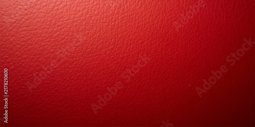 Vibrant red leather texture background with natural grain pattern and soft cinematic lighting for luxury automotive interior design