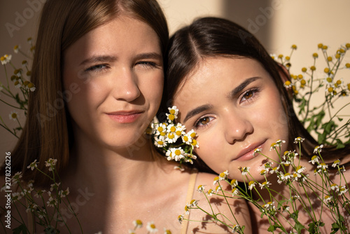 Fotografía Two young women with natural beauty, surrounded by delicate flowers, basking in