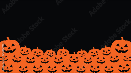 A festive halloween background featuring a large collection of carved orange pumpkins with spooky smiling faces arranged against a deep black backdrop