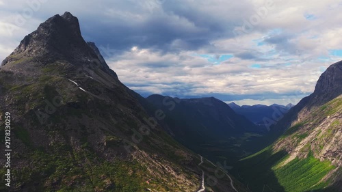 drone view capturing the dramatic canyon topography and winding road route of Trollstigen in Møre og Romsdal, Norway