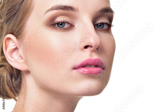 Beautiful Young Woman with Clean Fresh Skin. Close up Portrait.  Fashion Model Girl Face. Perfect Skin. Professional Makeup, gloss lips.