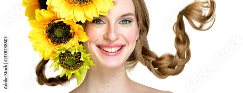 Canvas Print Laughing girl with sunflowers and braided pigtails