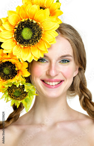 Foto Laughing girl with sunflowers and braided pigtails