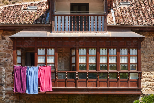 Picturesque wooden balcony with towels in Barcena Mayor. Cantabria, Spain