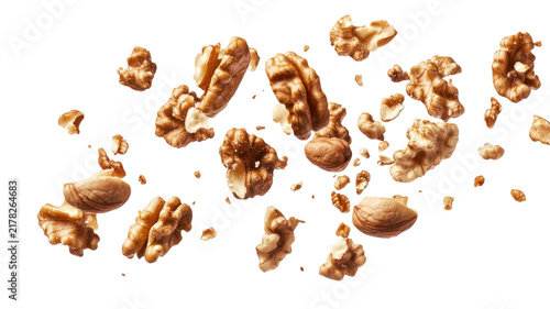 Golden walnut halves and pieces floating in midair isolated on a transparent background