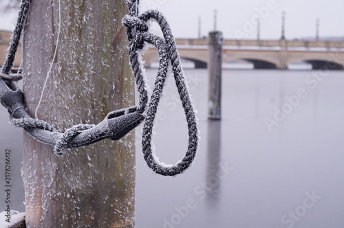 Photography Frozen mooring rope covered with frost at a winter marina