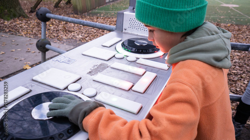 Принти на полотні Young boy playing interactive dj equipment in park