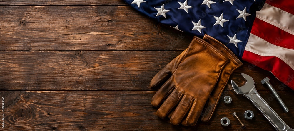 Obraz premium American National Holiday. US Flags with American stars, stripes and national colors. Construction and manufacturing tools on wooden background. Labor day background concept.