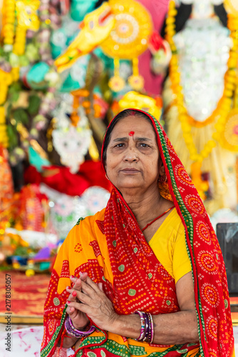 old age Woman devotee portrait with folded hand During Durga Puja Festival