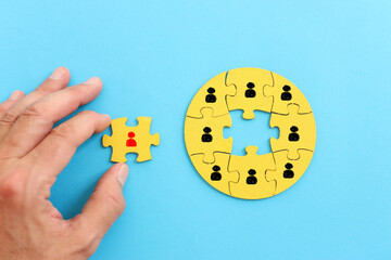 Wooden cubes with people icons over pastel background, human resources and management concept