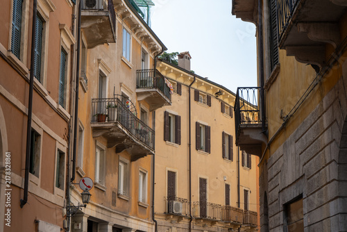 Charming narrow Street with Historic house Buildings and Balconies in Old Town Verona, Italy.