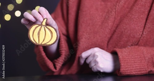 Pumpkin cookies in a woman's hands for Halloween

