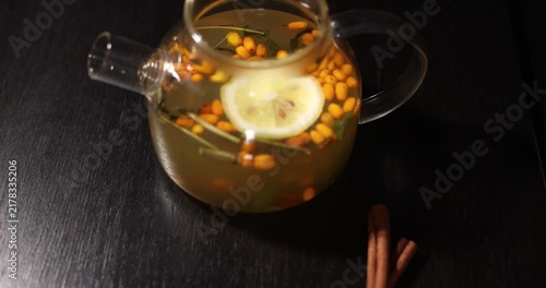 aromatic sea buckthorn vitamin tea on a dark background
