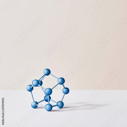 Abstract geometric structure of blue luminous particles on a fine lattice, featuring a matte finish and soft shadows with copy space for a SaaS cover
