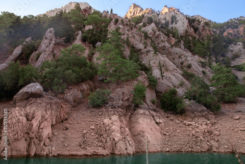 Emerald waters of Green Canyon, Turkey, surrounded by dramatic rocky cliffs