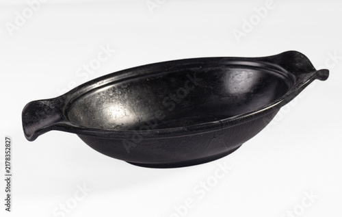 Fotografie Rustic black ceramic serving bowl with handles isolated on white