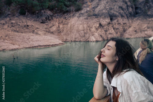 Young woman relaxing on a boat tour in Green Canyon, Turkey