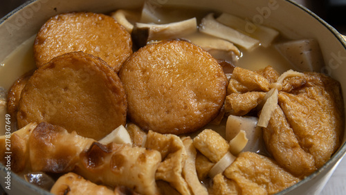 Фотография Simmering Japanese oden hot pot with fish cakes fried tofu pouches and soup in p