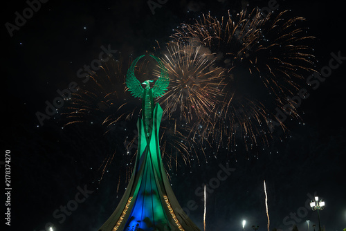 Spectacular colorful fireworks illuminating the Humo Bird Stella in Yangi Uzbekistan, Tashkent, Uzbekistan, at night. Dramatic festive scene featuring the iconic national symbol against a vibrant illu