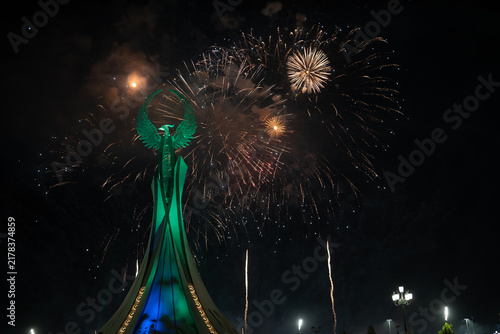 Spectacular colorful fireworks illuminating the Humo Bird Stella in Yangi Uzbekistan, Tashkent, Uzbekistan, at night. Dramatic festive scene featuring the iconic national symbol against a vibrant illu